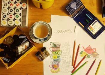 black and white ceramic mug on brown wooden table