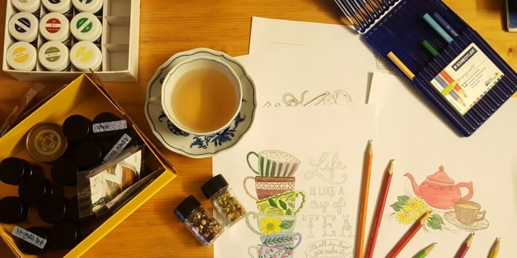 black and white ceramic mug on brown wooden table