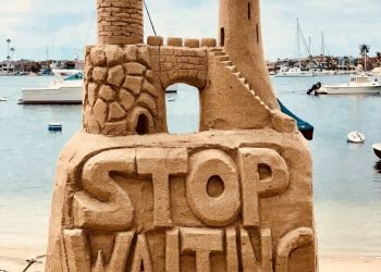 sand castle beside body of water