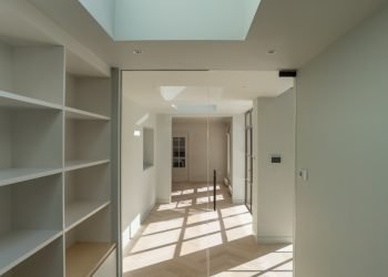 white wooden shelf near white wall