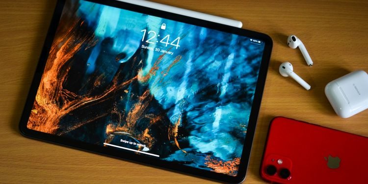 a tablet with a picture on it next to a red phone